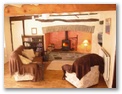 Hollywood Cottage - Holiday Cottages Wales - Living room toward main inglenook fireplace
